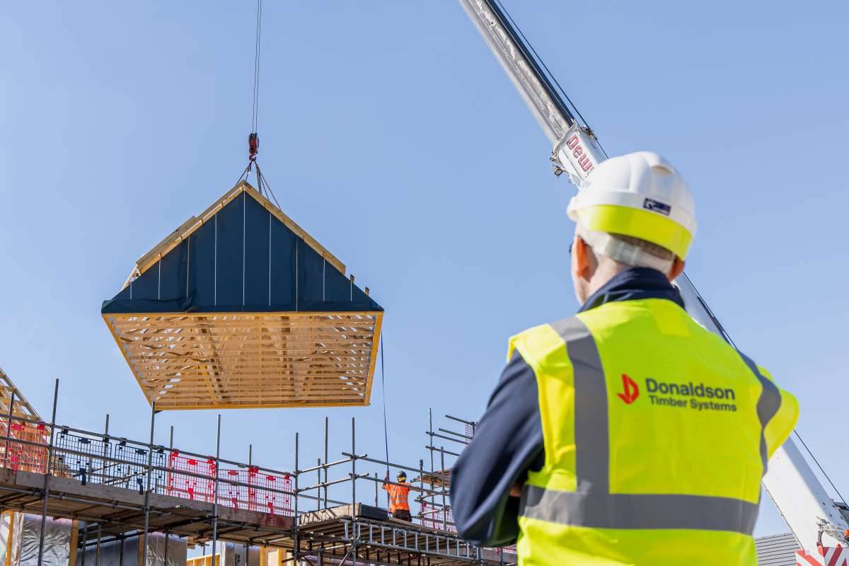 A roof being lowered by crane
